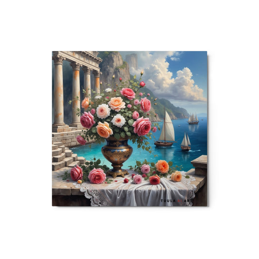 The image features a vibrant and picturesque scene with a large, ornate bronze vase filled with lush roses in various shades of pink, peach, and cream. The vase sits atop a white cloth-covered table against a backdrop of classical stone columns, serene blue skies, and calm seas where sailboats gently drift. Majestic cliffs rise in the distance. The artwork is signed “TUULA AI ART.”